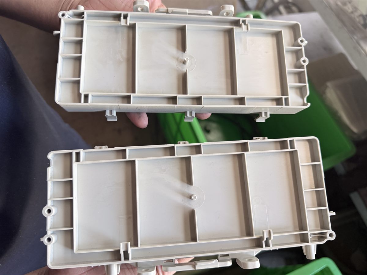 Two molded plastic housings showing internal ribs and mounting features